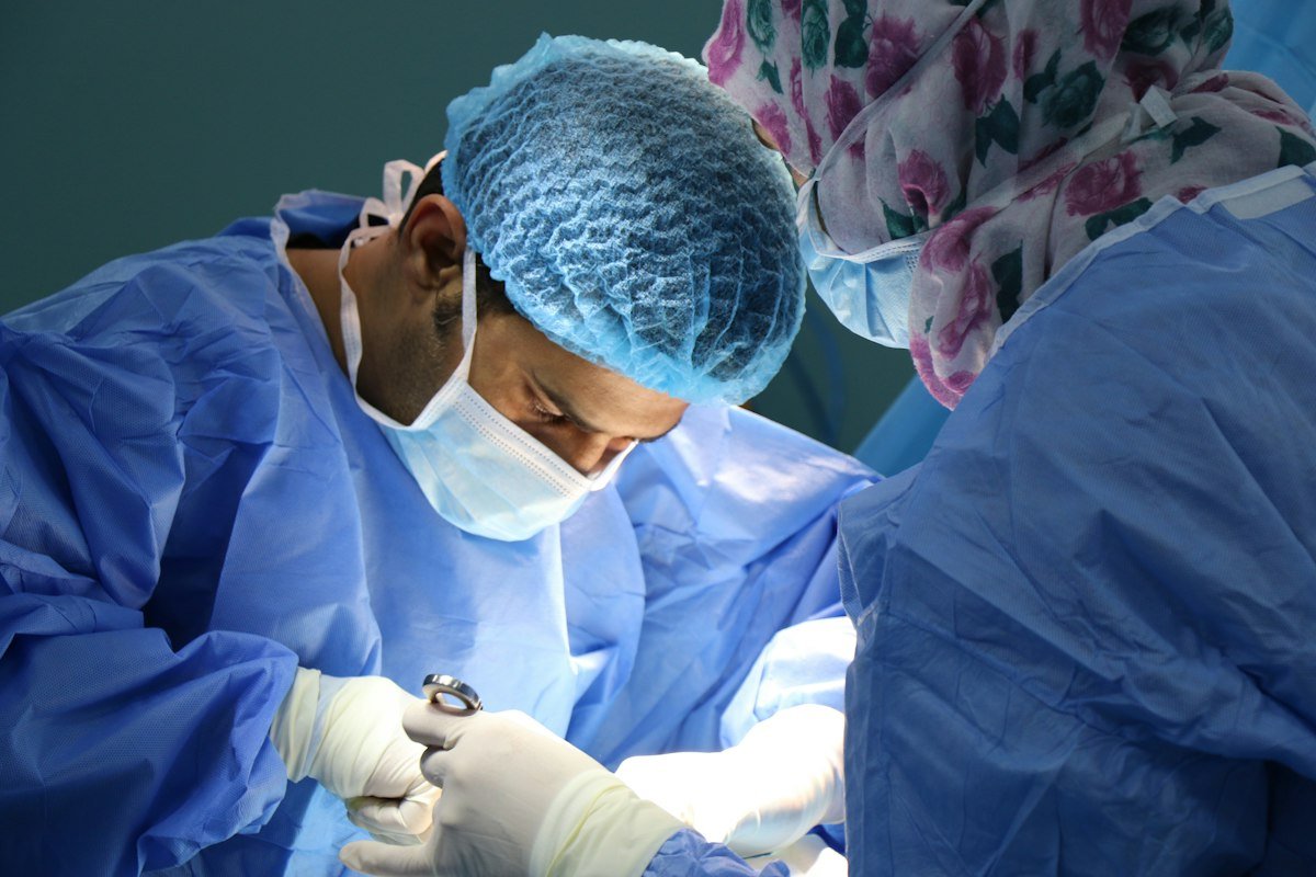 Doctor examining a patient with a hoarse voice to assess if it is serious